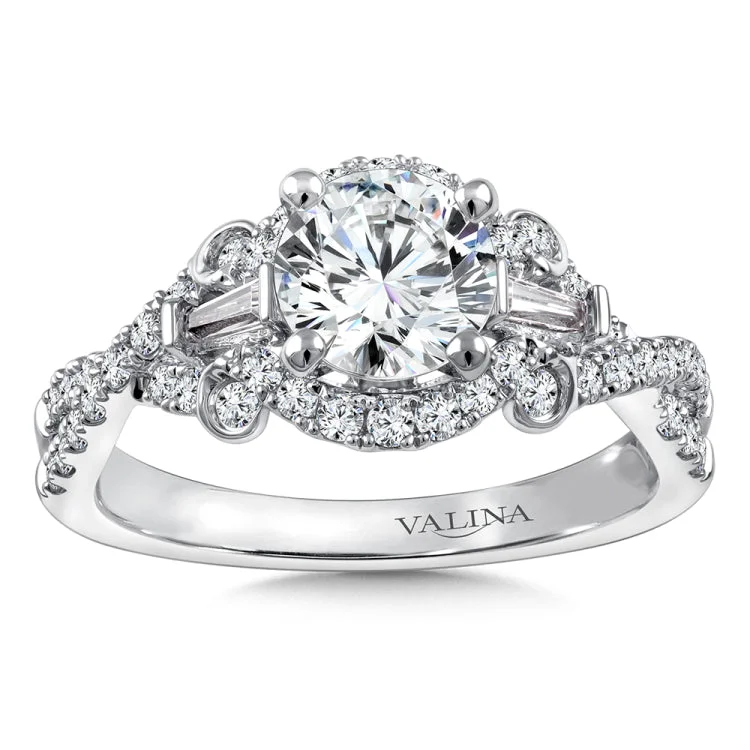 Diamond engagement ring mounting with tapered baguette and round side stones set in 14k white gold.