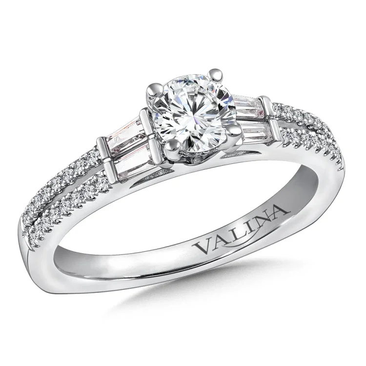 Diamond split shank engagement ring with baguette and round side stones set in 14k white gold.