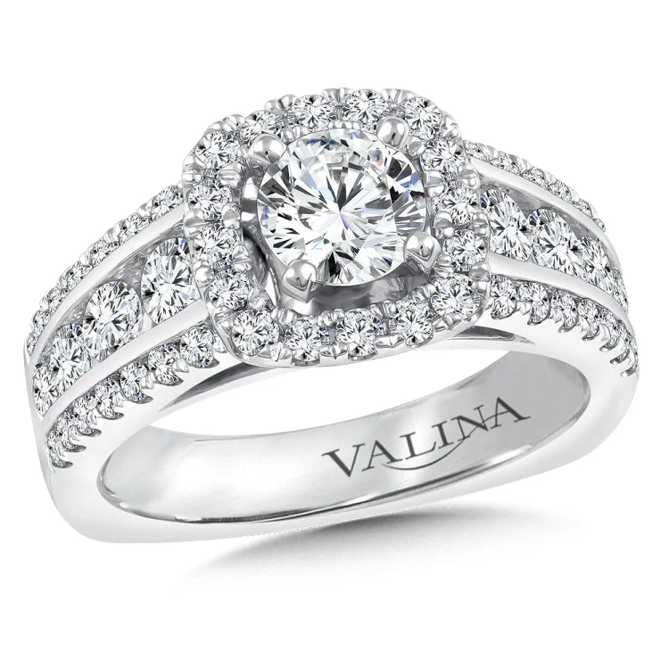 Diamond halo engagement ring mounting with side stones set in 14k white gold.