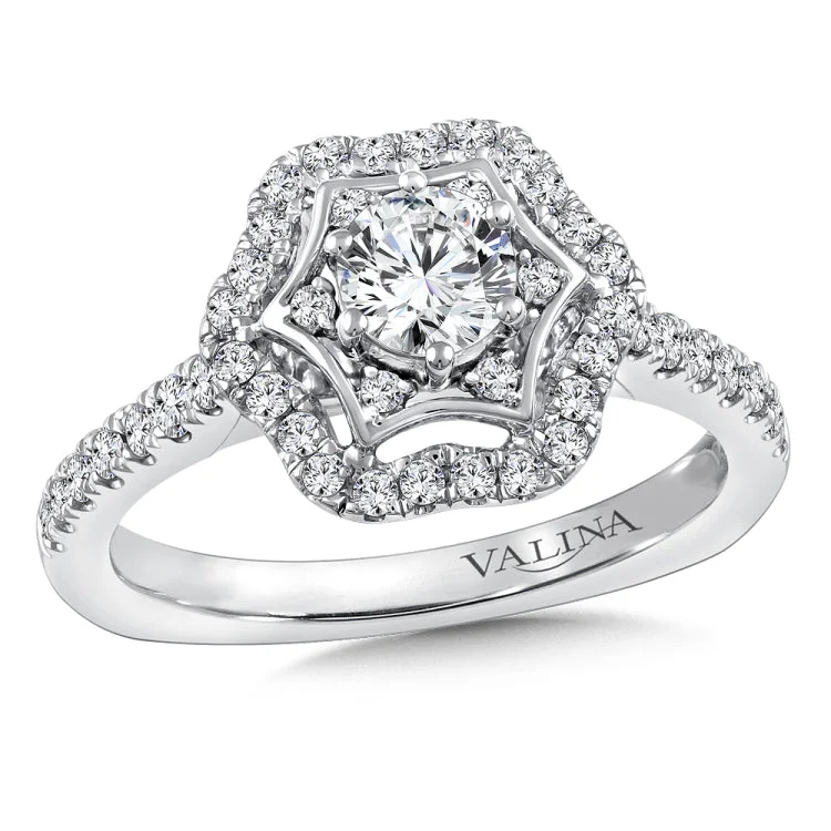 Diamond halo engagement ring mounting with side stones set in 14k white gold.